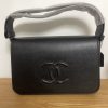 "The Postman Bag"—crafted from matte black cowhide for a stylish aesthetic. 25 x 16 cm.